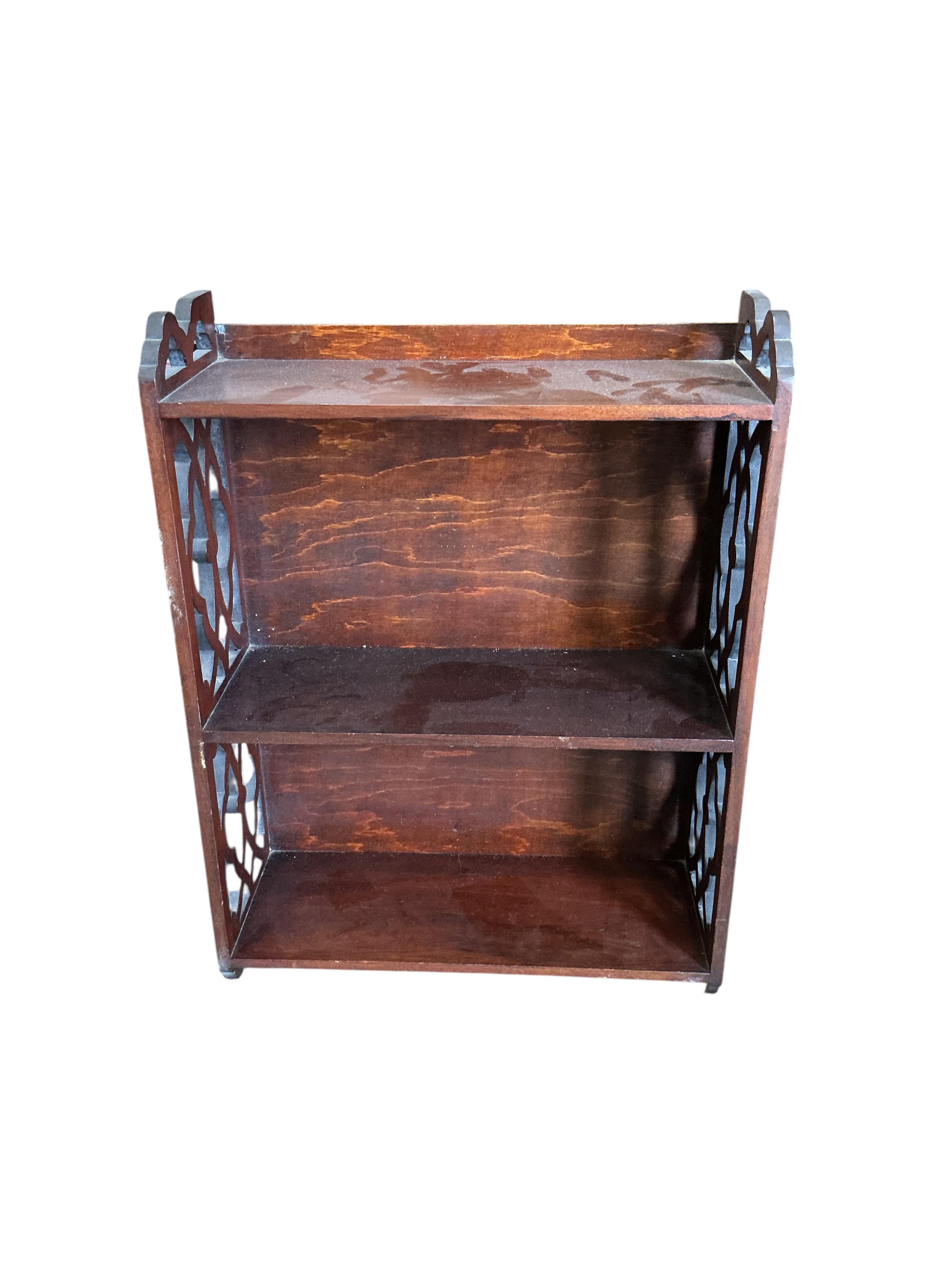 A late Victorian carved oak square two tier table, 59cm, height 66cm, together with a Victorian piano stool, a wall bracket and a Balinese wall mirror
